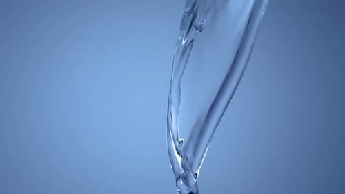 Pouring Water Splashing Against a Light Blue Background