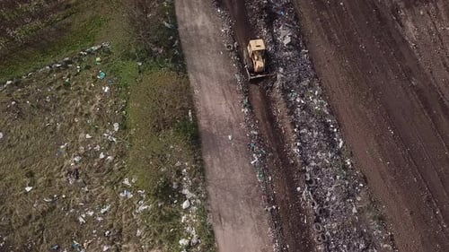 Bulldozer Moves Trash at Landfill, Aerial View