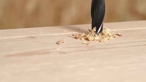Drill Bit Drilling Into Piece of Wood