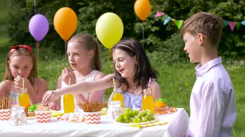 Happy Kids on Birthday Party at Summer Garden