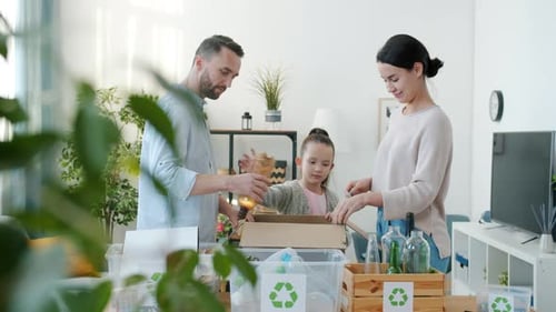 Family Sorts Recycling at Home Together