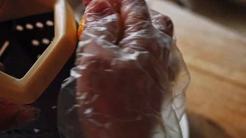 Gloved Hand Grating Lemon Zest Close Up