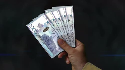Kazakhstan Tenge money fan of banknotes in hand