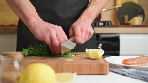 Chef Chopping Herbs on a Cutting Board