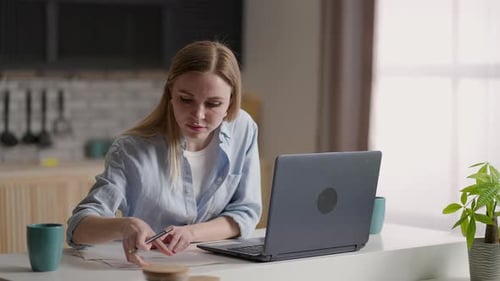 Concentrated Focused Woman Student or Freelancer Working at Laptop in Cafe or Coworking