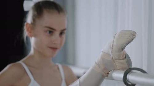 Young Ballet Dancer Stretching at the Barre