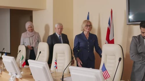 Group of Adults Gather Around Conference Table