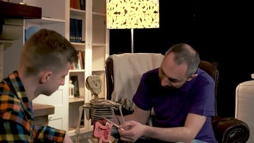 Dad Telling His Boy About the Function of Ribs in Human Skeleton