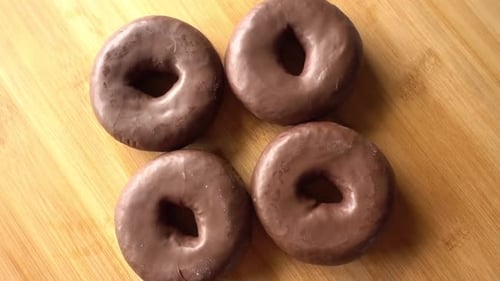 Chocolate Donuts Arranged on Wood Surface
