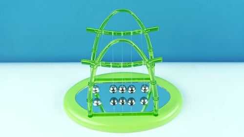 Green Pendulum Balls Newton On A Blue Background 1.