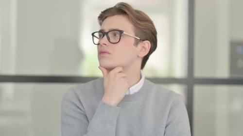 Portrait of Pensive Young Man Thinking