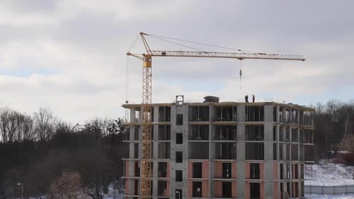 Construction site with big tower crane in time lapse with cloudscape.