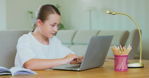 Girl Studying on Laptop at Home