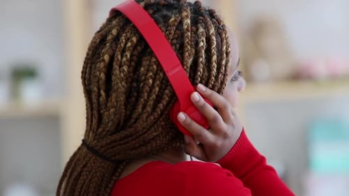 Woman Listening Music with Red Headphones