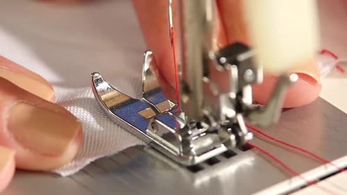 Close-Up of Sewing Machine Sewing White Fabric