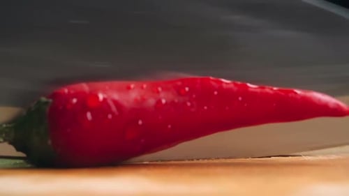 Cutting Fresh Red Chili Pepper in Half