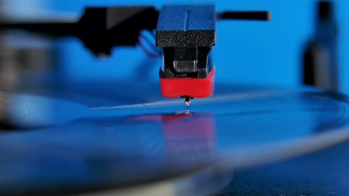 Vinyl Record Disc Spinning on the Classic Gramophone Player Against Colorful Background. Close Up