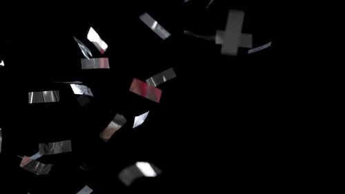 Silvery Ribbons of Confetti Falling Down on an Isolated Black Background