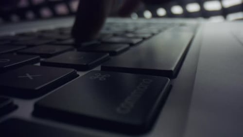 Fingers Typing on Laptop Keyboard Close Up