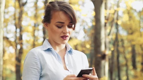 Woman with mobile phone. Woman spending time with mobile phone in park