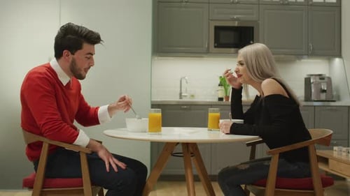 Young Adults Having Breakfast Together in Modern Kitchen