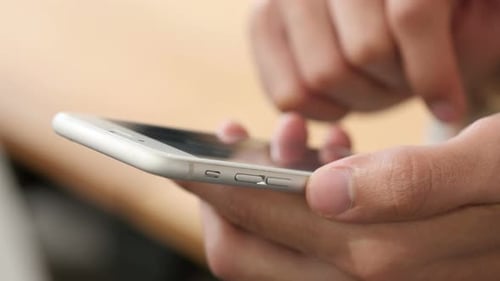 Hands Holding Mobile Phone