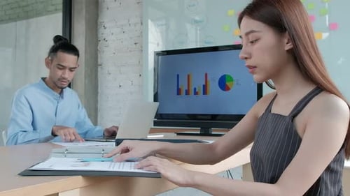 Team Members Reviewing Documents in a Modern Office