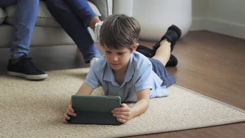 Child Using Tablet Device at Home