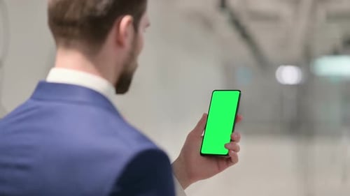 Businessman Using Smartphone with Green Chroma Key Screen