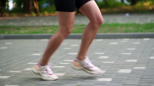 Female Athlete's Feet Running at the Park
