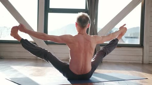 Man Practicing Yoga in Sunny Studio