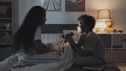 Children Chatting Together in Bedroom at Night