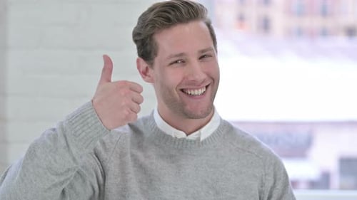 Smiling Young Adult Gives Thumbs Up of Approval