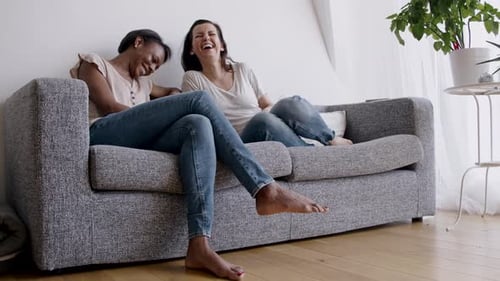 Two women talking on sofa