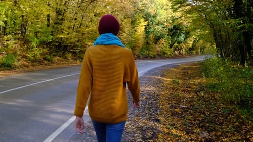 Pretty Smiling Asian Woman Walks in Autumn Woods