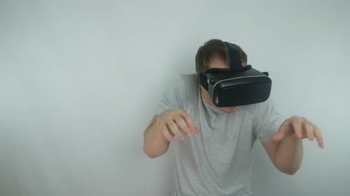 Man Uses A Virtual Reality Helmet In A Fighting Game Simulation Using The Style Of A Drunken Ninja