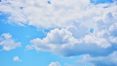 Billowing White Clouds Floating Across a Blue Sky
