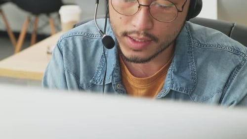 Close up shot of Asian business male call center officer working by talking to customer in office.