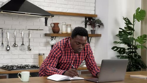 African American Man Student Study Does Homework for University with Laptop