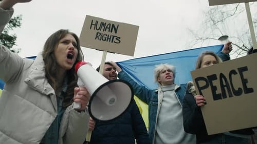 Group of young caucasian people manifesting against conflict in Ukraine. Shot with RED helium camera