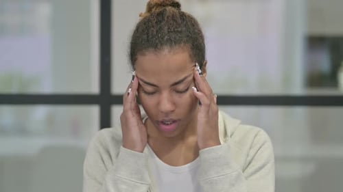 Woman Massaging Temples Due to Headache Pain