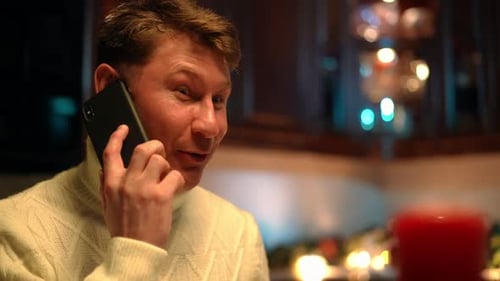 Man Laughing While Talking on the Phone