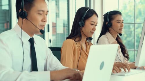 Business People Wearing Headset Working Actively in Office