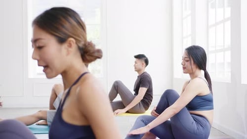 Asia group of women exercising yoga healthy lifestyle in fitness studio.