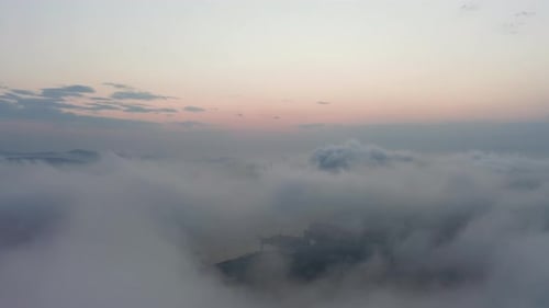 Drone View of the City Bay and Big Bridge Covered with Fog at Sunset