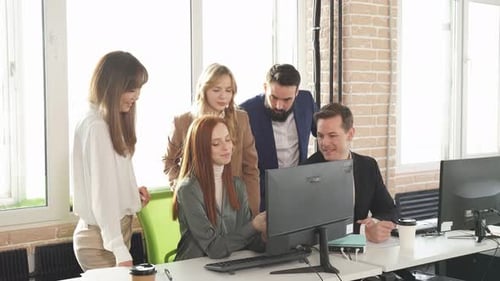 Group of a Young Business People Brainstorming and Discussing Business Plan in Office