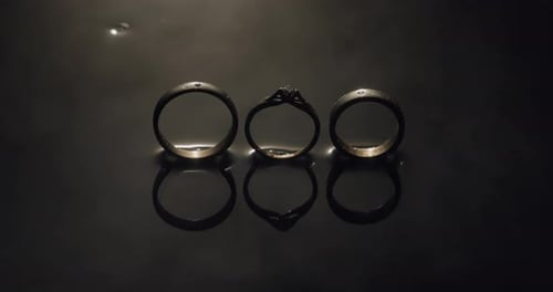Wedding Rings Reflecting on Black Surface