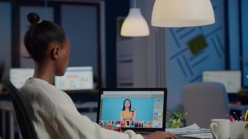 Graphic Designer Works on Laptop in Modern Office