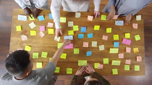 Top View of Business Team Working with Sticky Notes during Meeting