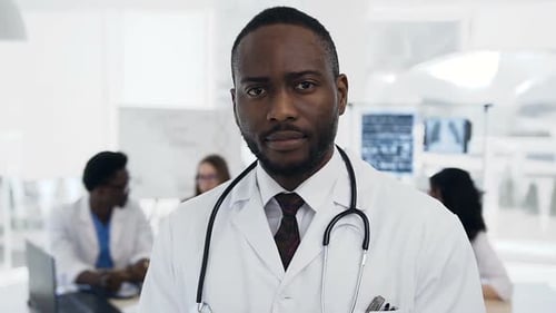 Smiling Doctor in White Coat at Modern Hospital